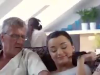 Skillful old man manages to fuck comely brunette on sofa