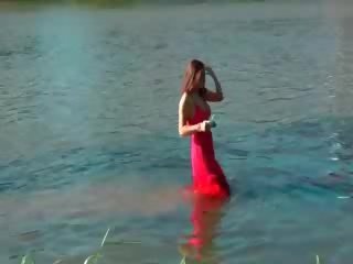 Superb brunette getting wet in the lake